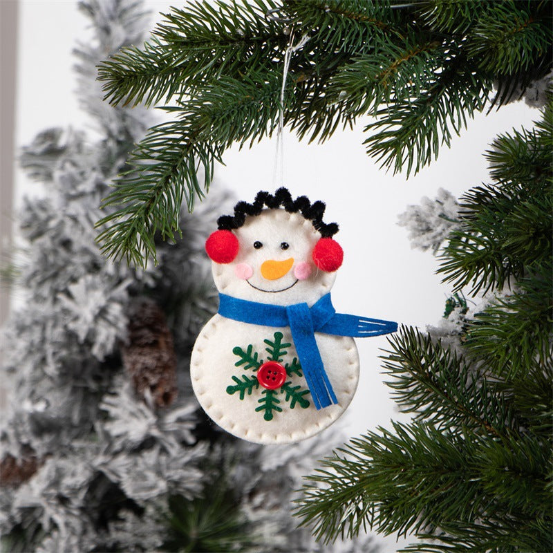 Snowman pendant hanging on Christmas tree branch