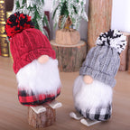 Red cloth ski doll Christmas ornament hanging on tree branch