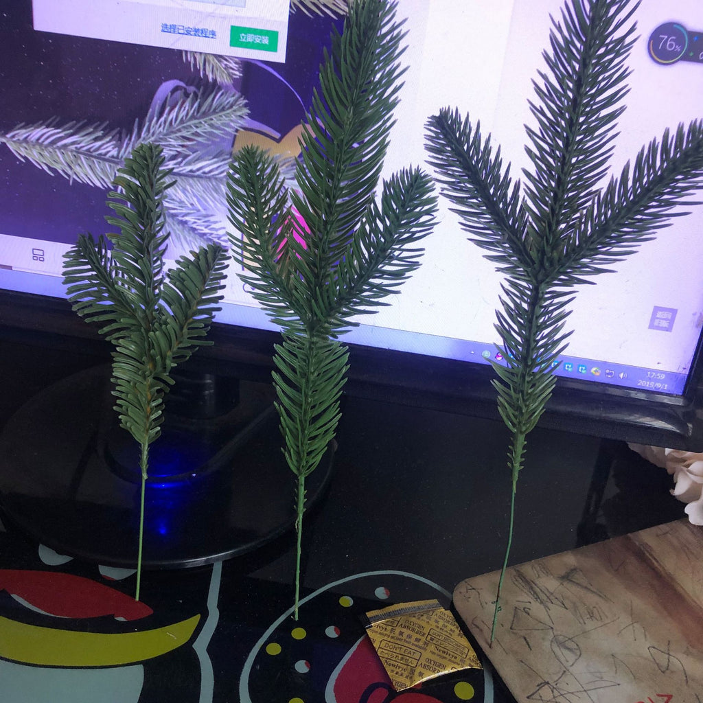 Green simulation pine needle sprays arranged as Christmas tree picks with rich evergreen foliage