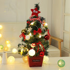 Mini Christmas tree standing freely on a surface with bows and star tree topper