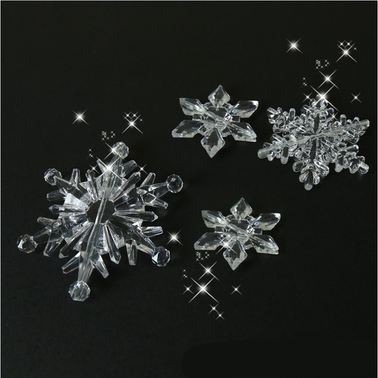 Crystal acrylic Christmas snowflake ornaments arranged decoratively with holiday lights