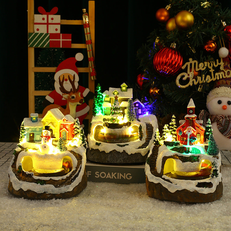 Festive Christmas village scene featuring rotating train decoration