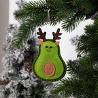 Three felt tree pendants hanging on a Christmas tree branch