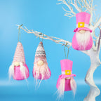 Assorted plush Christmas figures in pink and grey for holiday shelf display