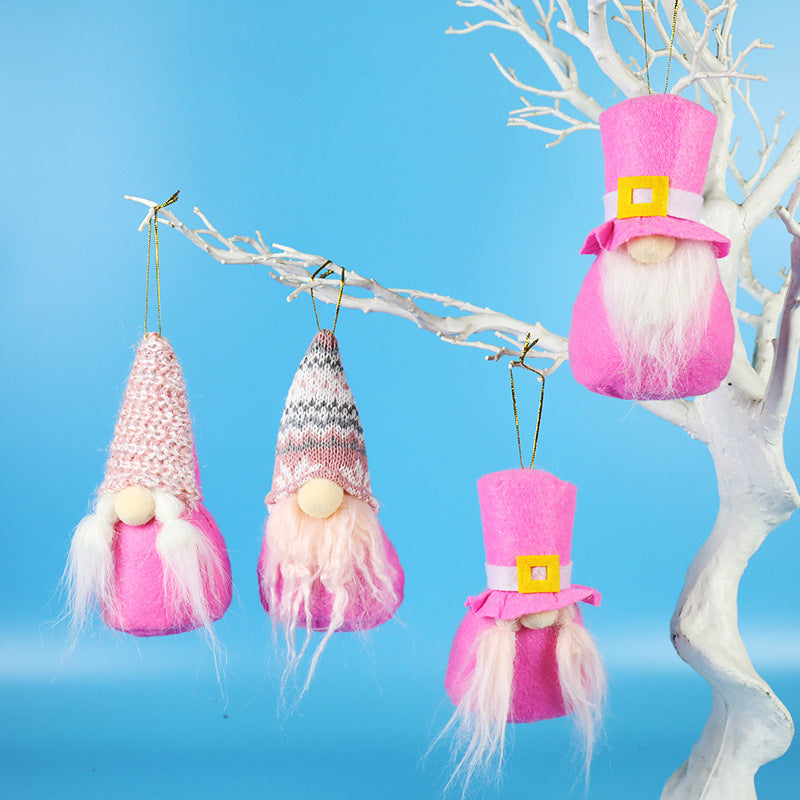 Assorted plush Christmas figures in pink and grey for holiday shelf display