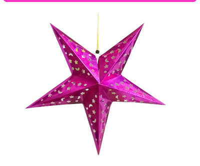 Five-pointed star ornament in gold reflecting warm light for Christmas tree
