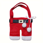 Red Christmas napkin holder set shaped like folded clothes on table