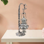 Ornate hanging metal censer with decorative cover and chain suspension