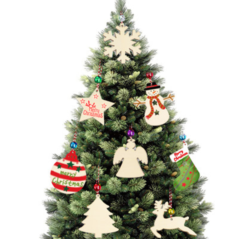 Rustic unfinished wooden Christmas tree pendant on warm wooden surface with craft paints nearby