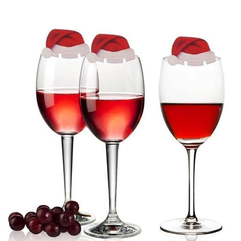 Wine glasses with Christmas toppers at dinner party - Christian holiday celebrations