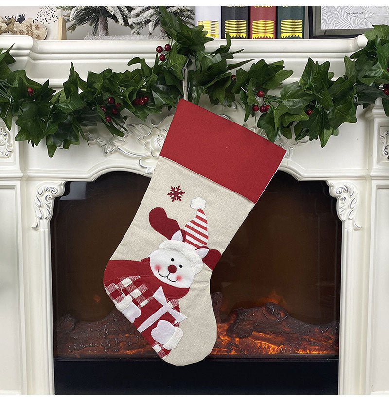 Cross-adorned Christmas stocking hanging decoration with festive pattern