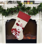 Cross-adorned Christmas stocking hanging decoration with festive pattern