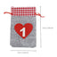 Christmas drawstring gift bag with cloth fabric texture showing drawstring closure for holiday gifting