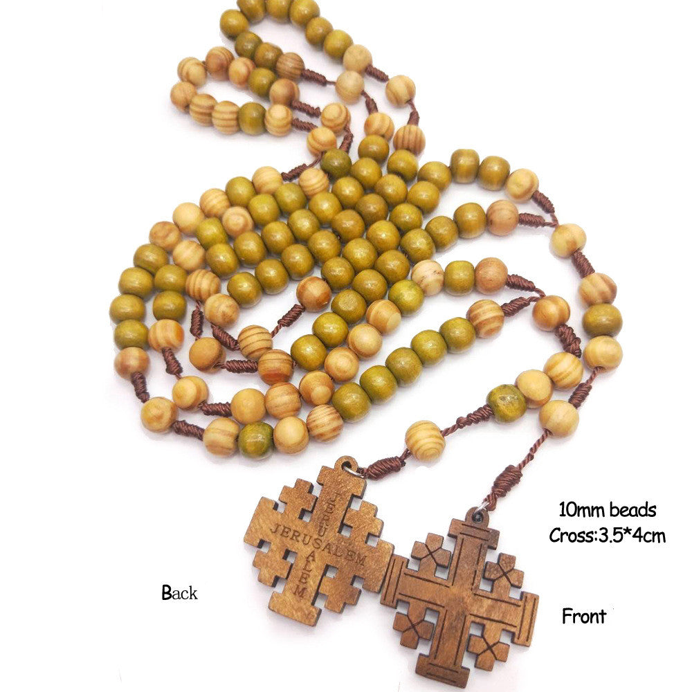 Person wearing wooden rosary crucifix necklace