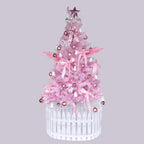Pink pencil Christmas tree with metal cross base in modern home setting