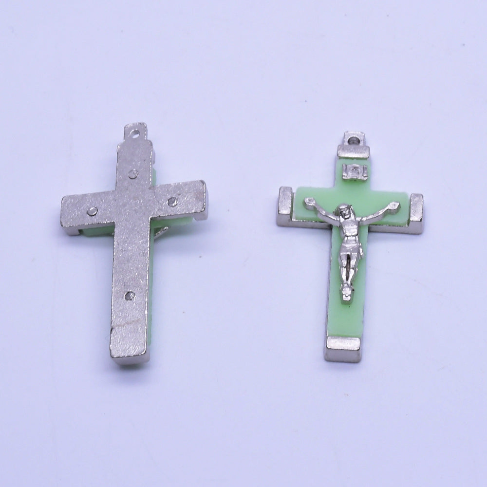 Christian pendant detail showing polished metal finish and symbolic imagery