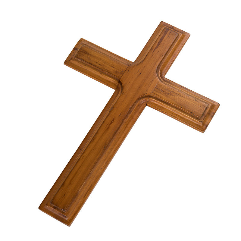 Apricot pine cross pendant with smooth finish hanging against a light background