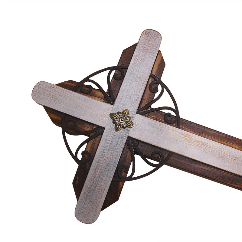 Detailed view of cross pendant highlighting the grinding process finish and natural wood grain