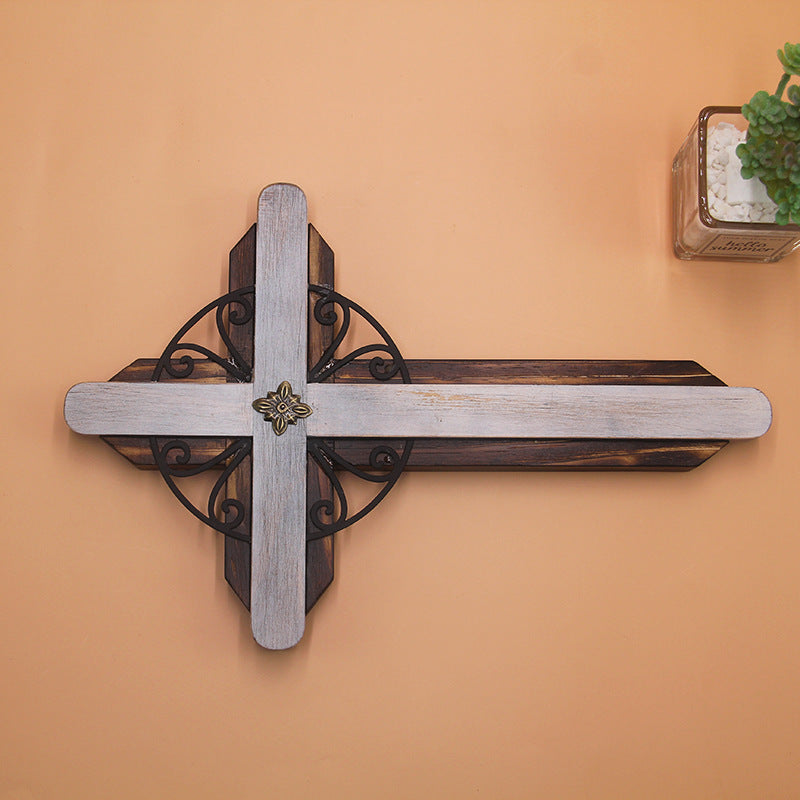 Apricot colored wooden cross pendant displayed on decorative fabric