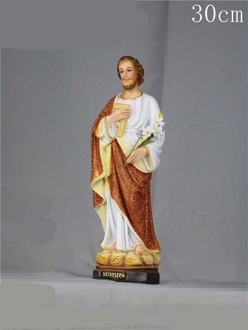 Catholic home decor arrangement with Jesus statue and bible