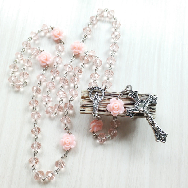 Jesus cross necklace front view showing rosary-style pink pendant