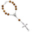 Wooden beads rosary bracelet with cross centerpiece on neutral background