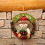 Circular Christmas garland with festive holiday motifs for door and window decoration