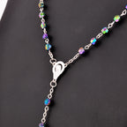 Colorful horn bead rosary necklace with alloy crucifix pendant displayed against a warm background