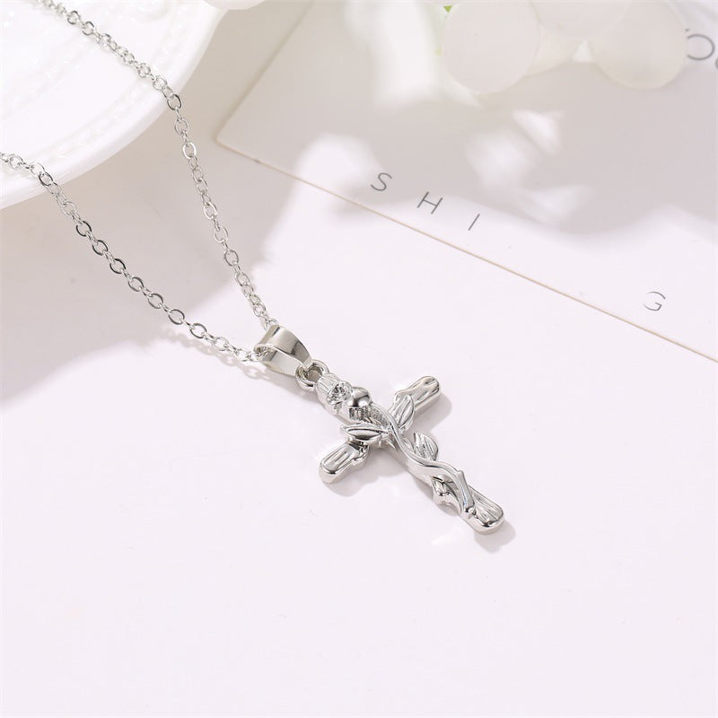 Simple women's faith necklace featuring cross and leaf pendant