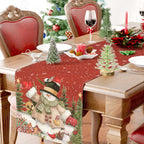 Holiday table setting with snowman linen runner for Christmas dinner