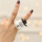 Set of 4 Christmas finger lights glowing warmly on a surface