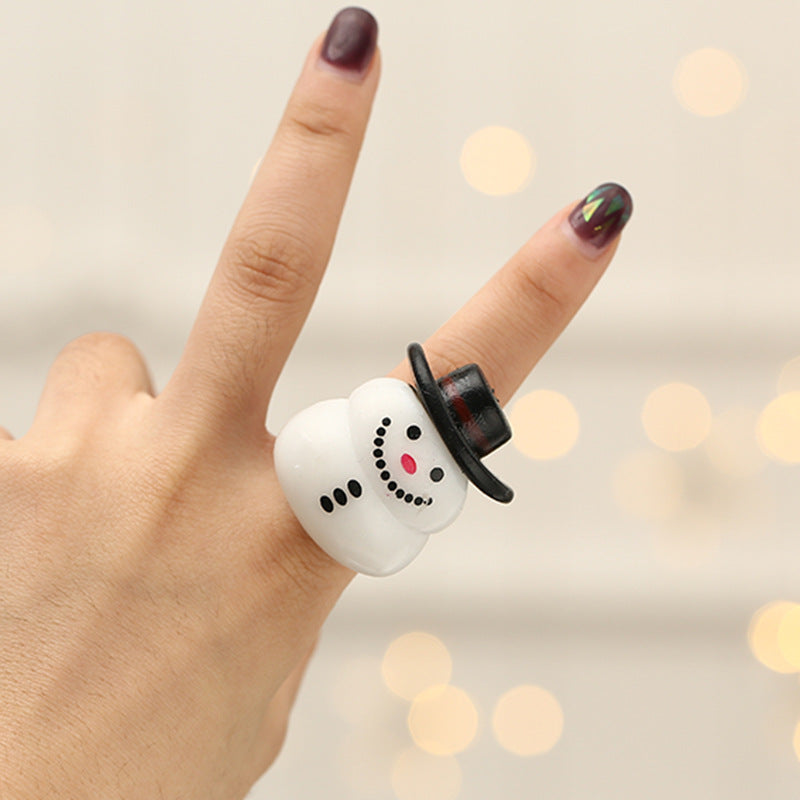 Set of 4 Christmas finger lights glowing warmly on a surface
