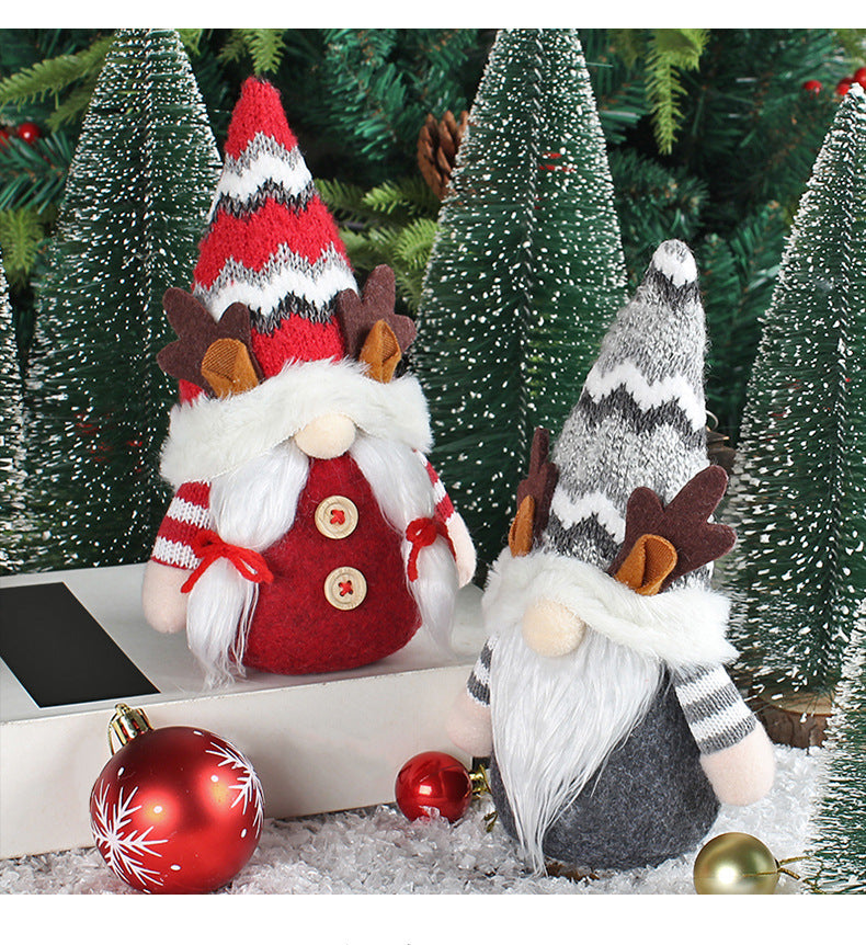 Red antler deer doll with pointed holiday hat on rustic Christmas display shelf