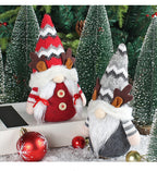 Red antler deer doll with pointed holiday hat on rustic Christmas display shelf