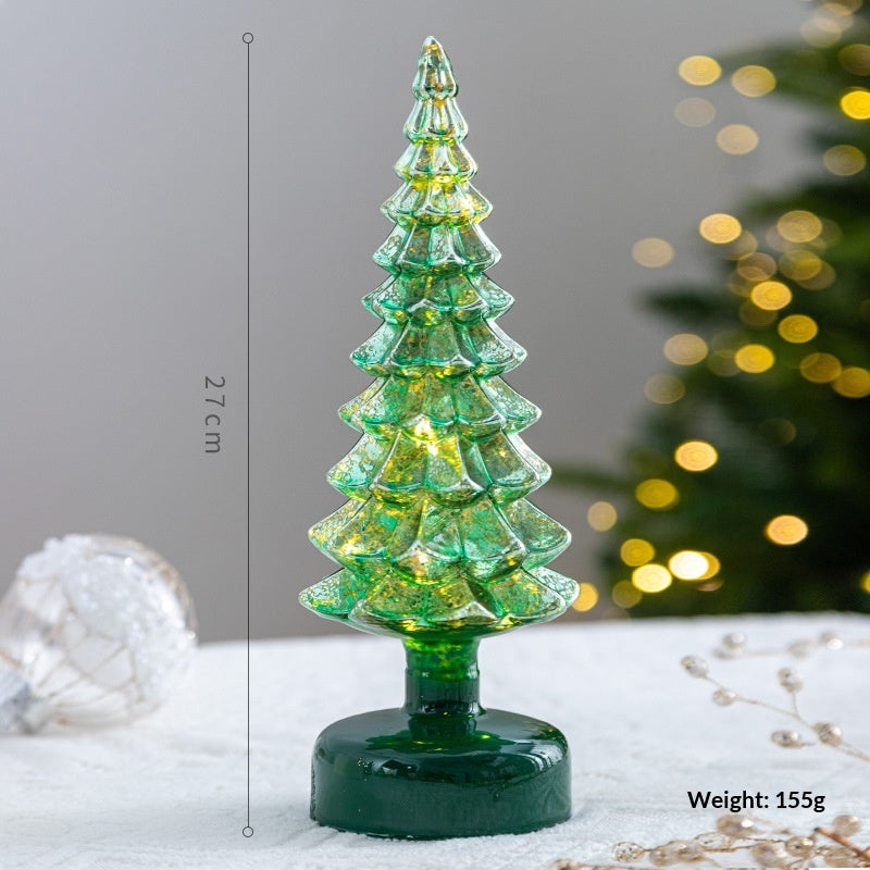 Crystal glass rainbow star ornament reflecting light on Christmas tree branches