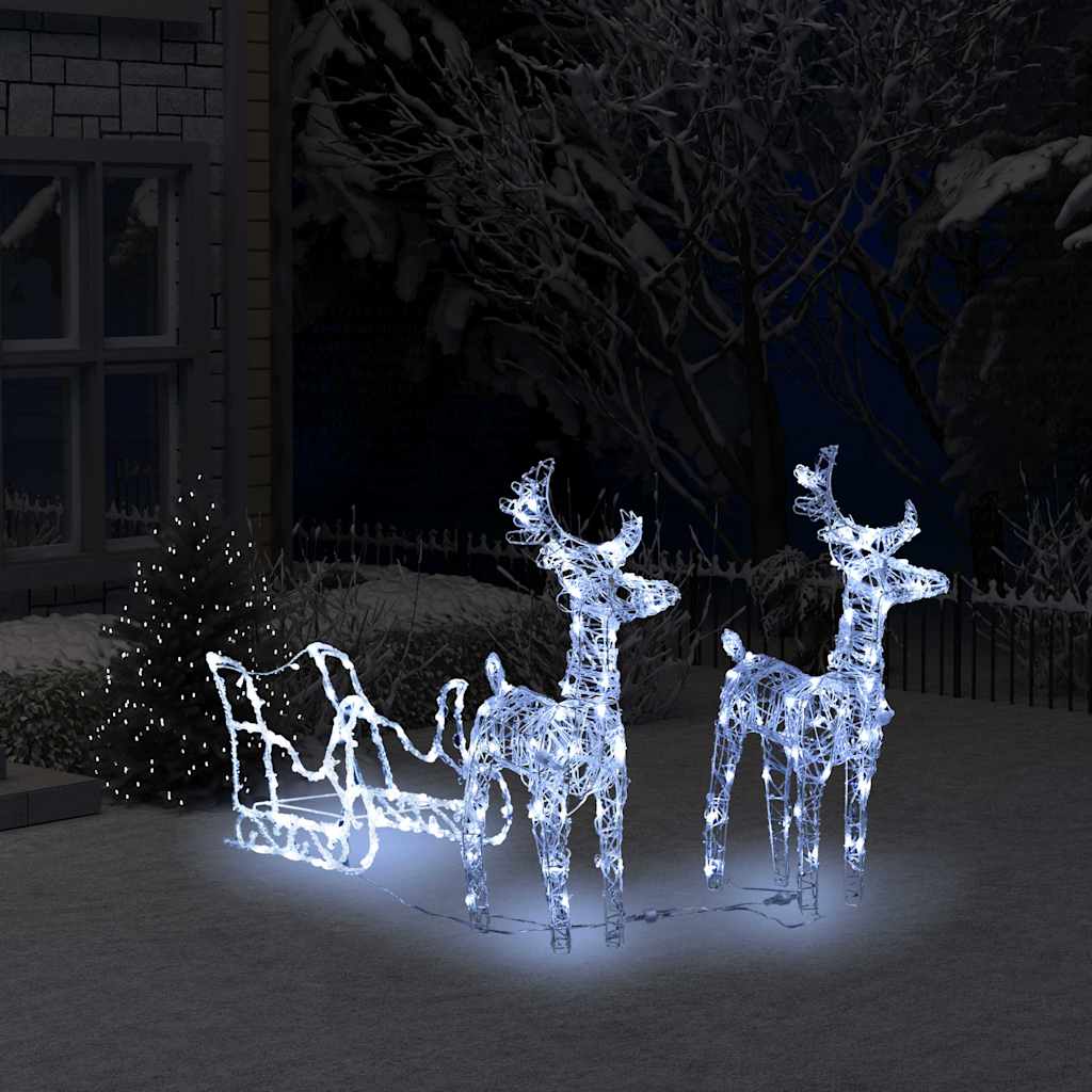Illuminated reindeer and sleigh with warm white LEDs glowing against night sky