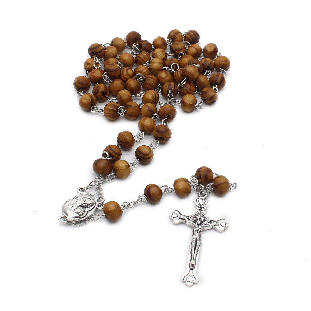 Wooden rosary with cross pendant displayed on dark background