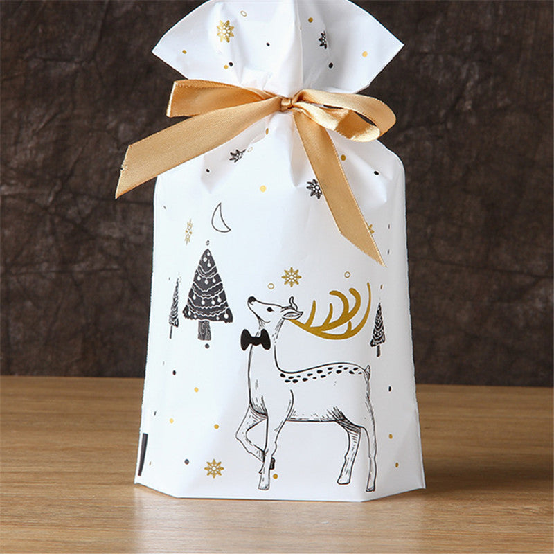 Green Christmas gift bag featuring forest creatures holiday theme