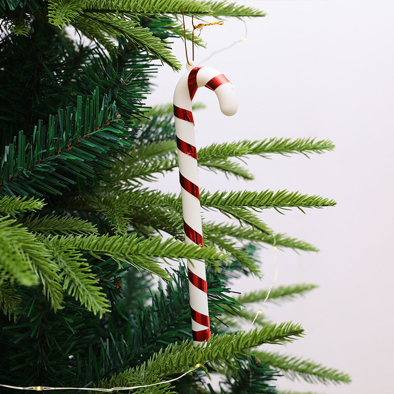 Red and white plastic Christmas tree crutches on display