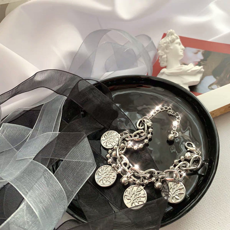 bracelet laid flat displaying the layered pendant design