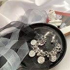 bracelet laid flat displaying the layered pendant design