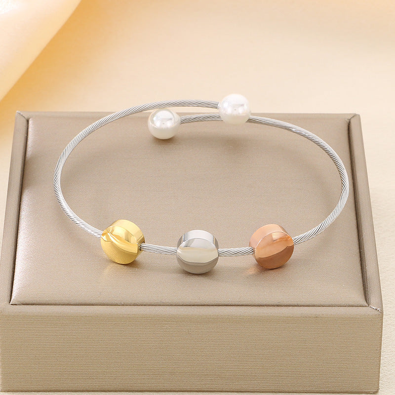 Retro cross-knot stainless steel bracelet with ring-shaped accent on neutral background - faith jewelry piece Main image