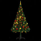 Illuminated artificial Christmas tree with colorful baubles creating warm holiday atmosphere