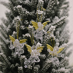 Set of four clear angel ornaments arranged in festive gift box styling