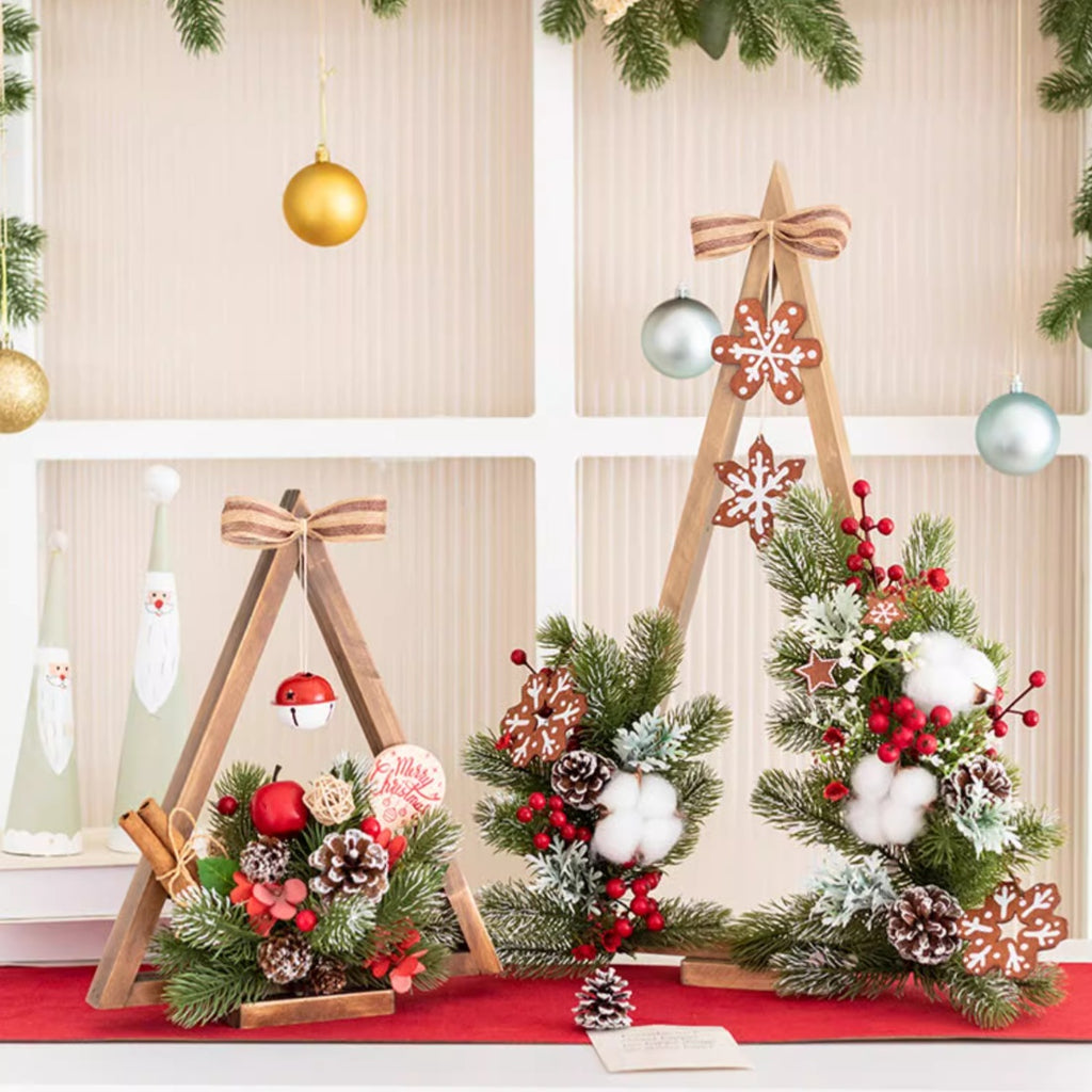 Christmas decoration showing detailed artificial flower arrangement on wooden base with lights