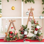 Christmas decoration showing detailed artificial flower arrangement on wooden base with lights