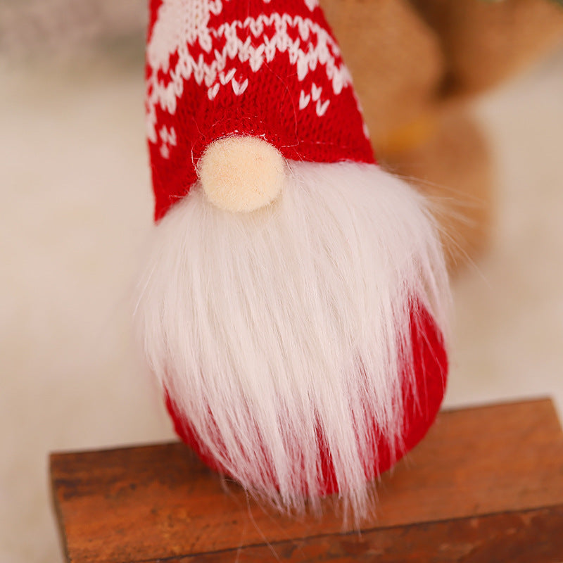 Christmas forest gnome ornament hanging on evergreen tree surrounded by soft bokeh lights
