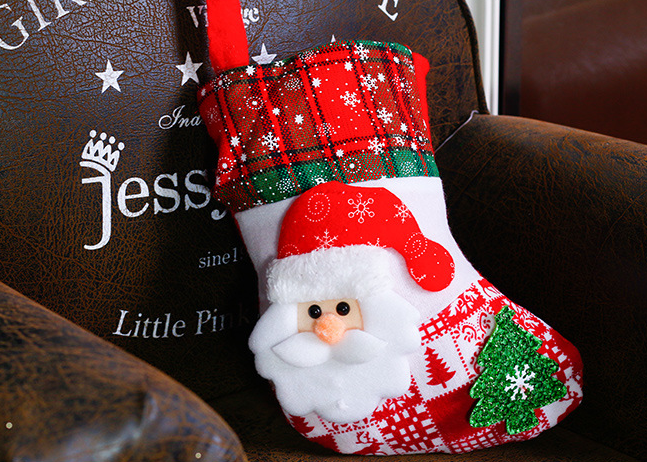 Set of four festive cloth sock ornaments in seasonal colors