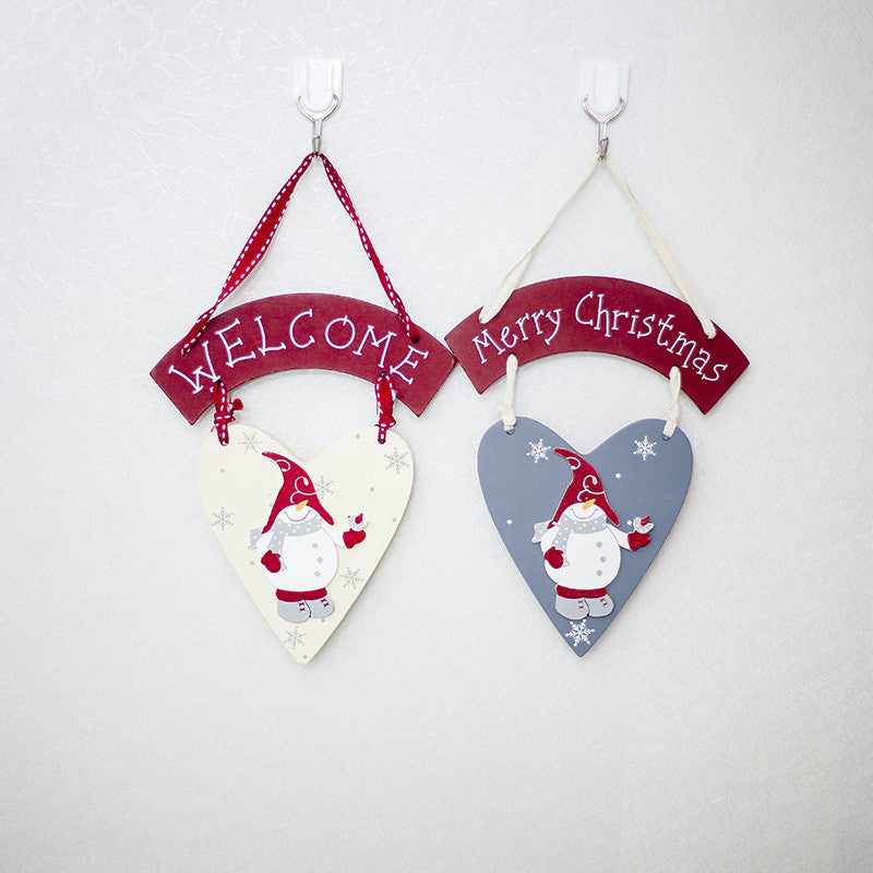 White snowman Christmas hanging ornament on wooden background, festive holiday decor Main image