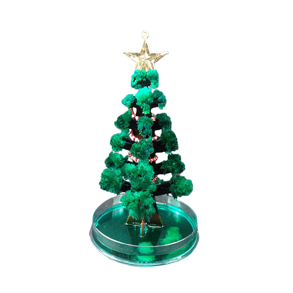Assembled Magic Growing Paper Christmas Tree decoration on wooden surface